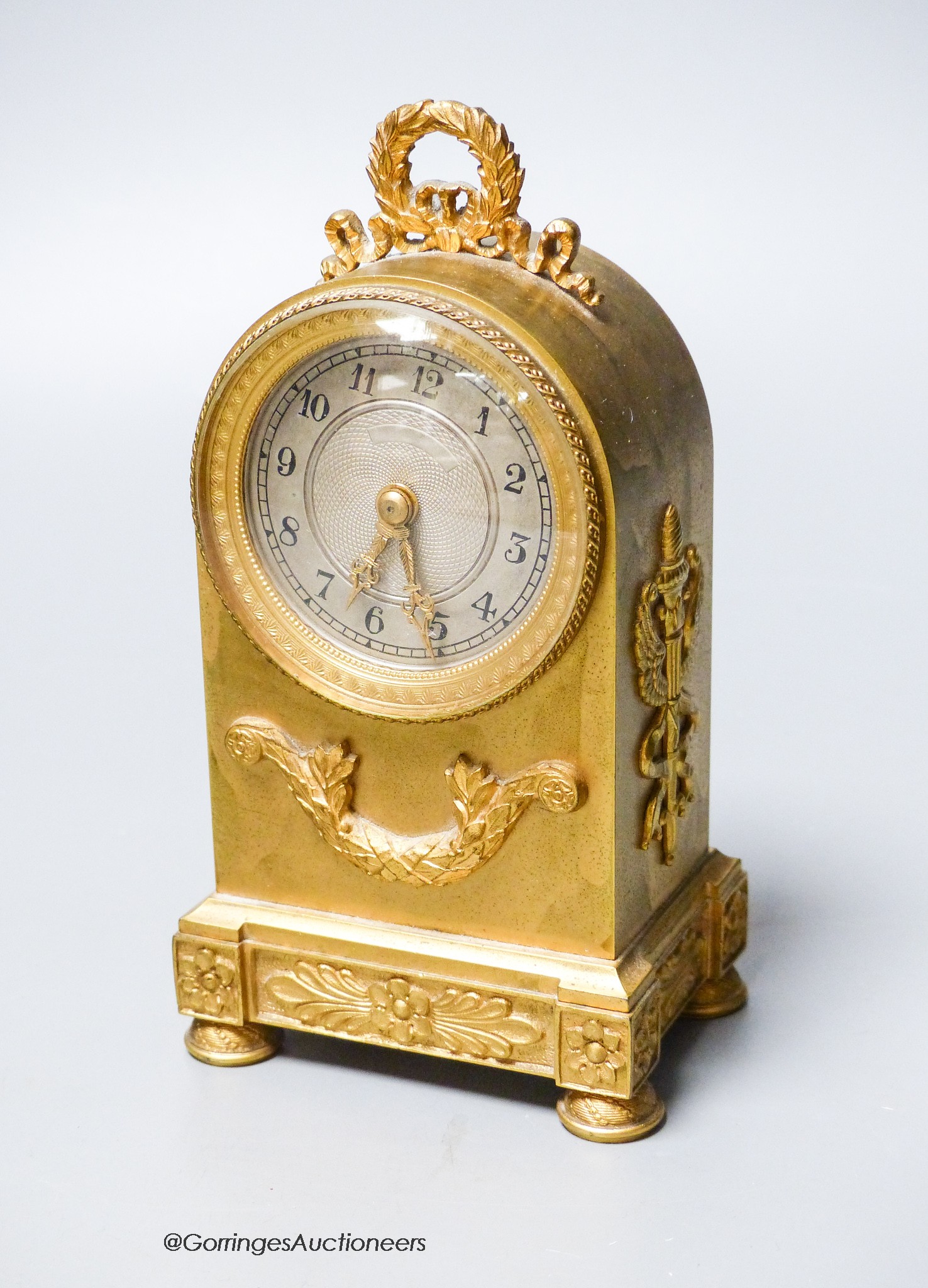 A small French gilt brass cased mantel timepiece, c.1900, of arched form, 15.5cm high.